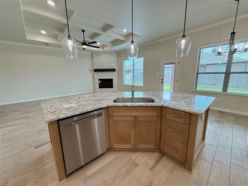 Kitchen with dishwasher, open floor plan, ceiling fan, coffered ceiling, and light wood finished floors