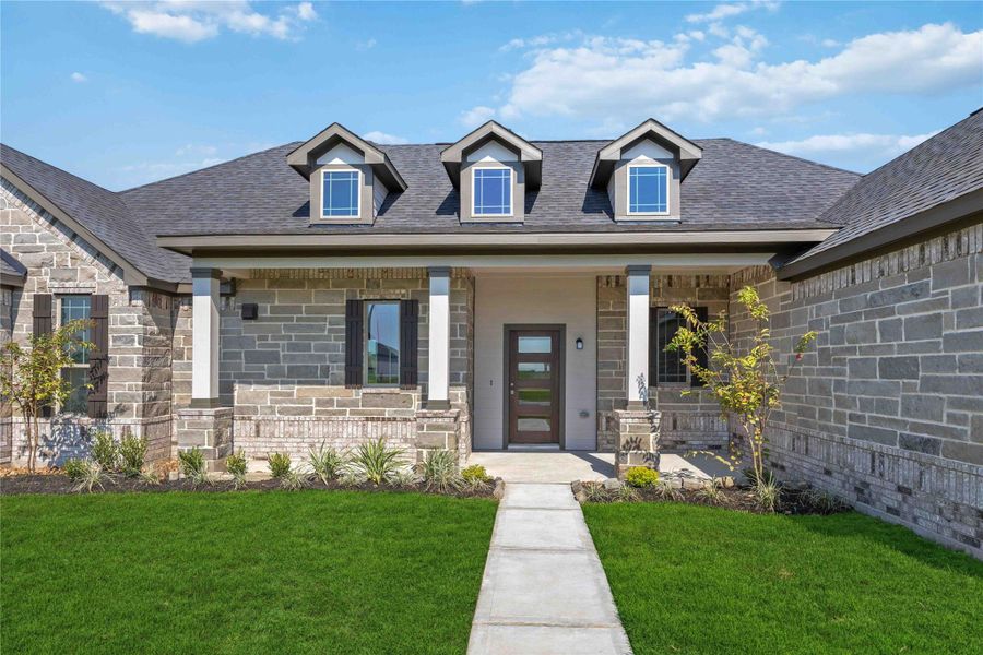 Front exterior of a new home in Blue Heron Estates, Beasley, TX, highlighting curb appeal (Image 14).