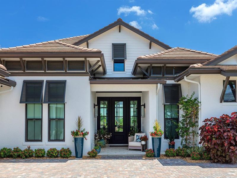 Front exterior of a new home in Wild Blue at Waterside, Sarasota, FL, highlighting curb appeal (Image 24). Front exterior of a new home in Wild Blue at Waterside, Sarasota, FL, highlighting curb appeal (Image 24).