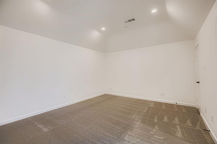 Unfurnished room with recessed lighting, dark carpet, and lofted ceiling Unfurnished room with recessed lighting, dark carpet, and lofted ceiling