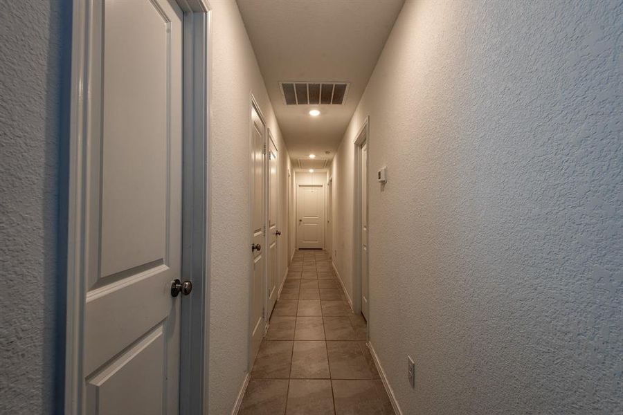 Corridor with light tile patterned floors