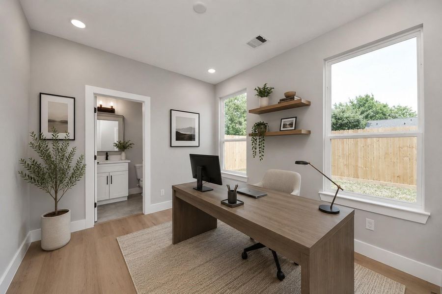 Versatile guest bedroom perfect for a home office, featuring abundant natural light, modern finishes, & a private ensuite bath.
