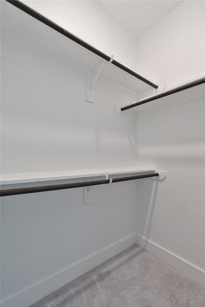 Secondary bedroom closet boasts multiple shelves for maximum space usage.