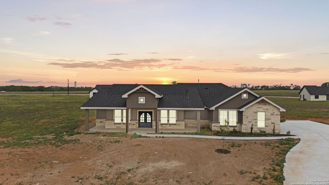 Front exterior of a new home in , Floresville, TX, highlighting curb appeal (Image 22).