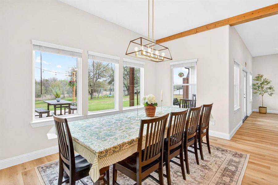Dining room featuring light wood-style floors and a chandelier Dining room featuring light wood-style floors and a chandelier