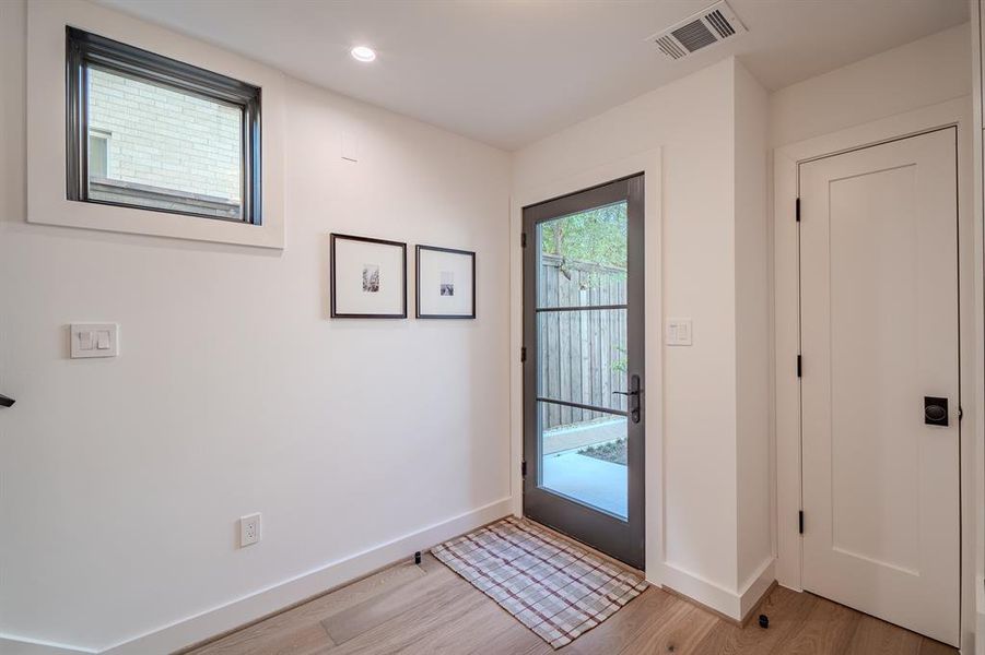 Doorway to outside featuring wood finished floors and recessed lighting