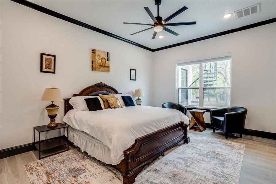 Bedroom with light tile-style floors, ornamental molding, a ceiling fan, and recessed lighting