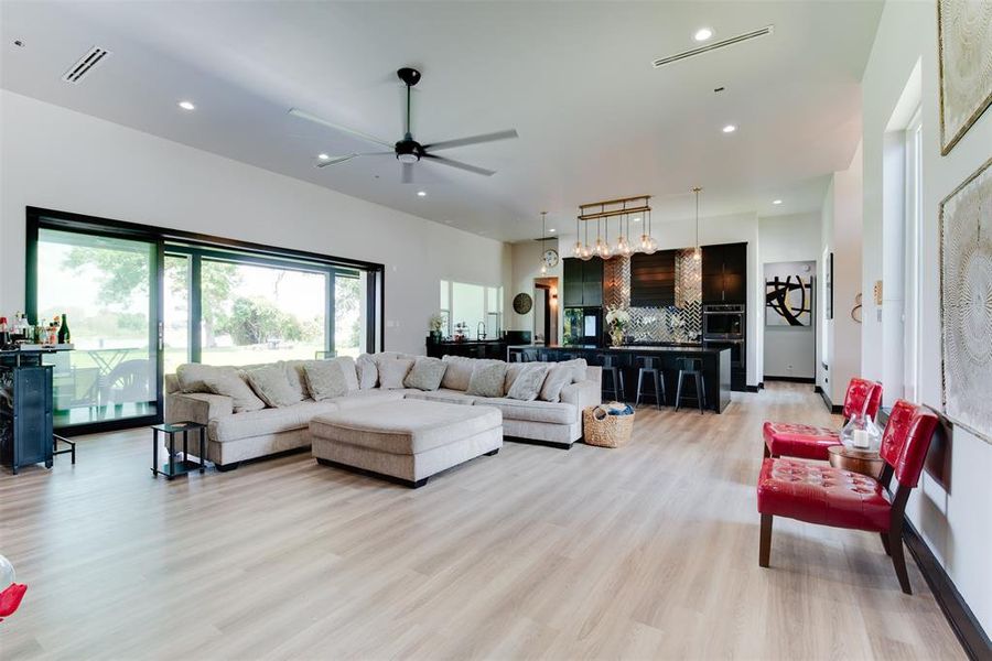 FAMILY ROOM WITH SLIDING DOORS LEADING TO LARGE COVERED PATIO