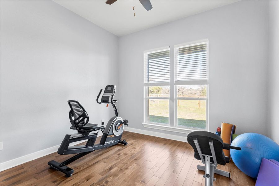 Used as a Workout area featuring wood-style floors and a ceiling fan or Bedroom #2