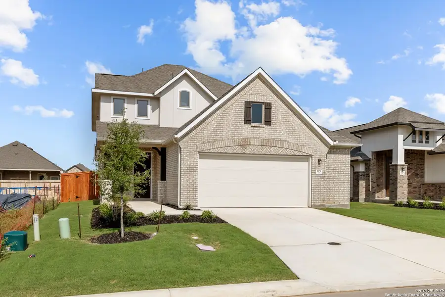 Front exterior of a new home in Megan's Landing, Castroville, TX, highlighting curb appeal (Image 1).