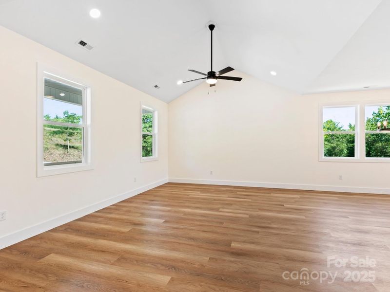 Upon entry is the living room with vaulted ceilings
