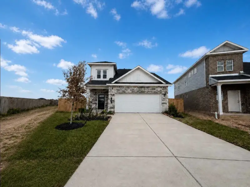 Front exterior of a new home in La Segarra, Brookshire, TX, highlighting curb appeal (Image 1). Front exterior of a new home in La Segarra, Brookshire, TX, highlighting curb appeal (Image 1).