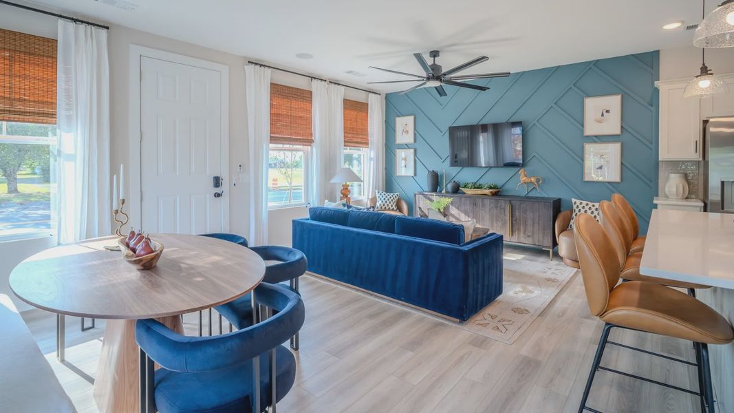 View of dining area and living area with natural lighting from windows