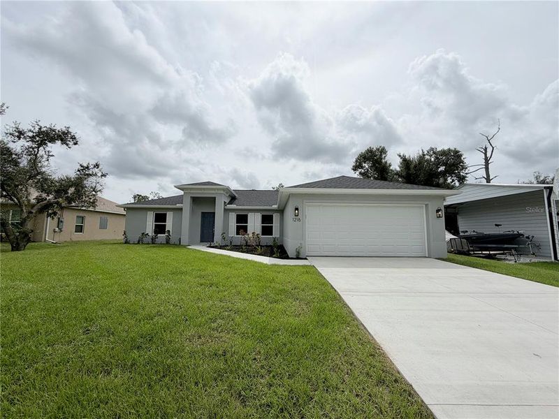 Front exterior of a new home in , North Port, FL, highlighting curb appeal (Image 1).