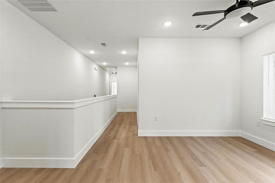Unfurnished room with light wood finished floors, recessed lighting, and a ceiling fan Unfurnished room with light wood finished floors, recessed lighting, and a ceiling fan