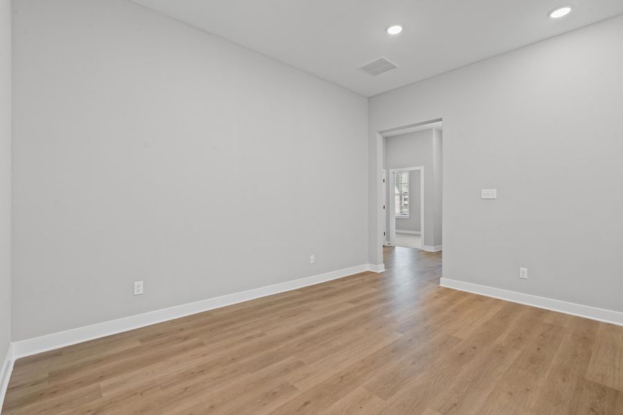 Spare room with light wood-style floors and recessed lighting