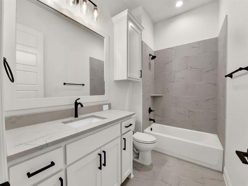 Bathroom featuring vanity, shower combination, recessed lighting, toilet, and marble finish floor Bathroom featuring vanity, shower combination, recessed lighting, toilet, and marble finish floor