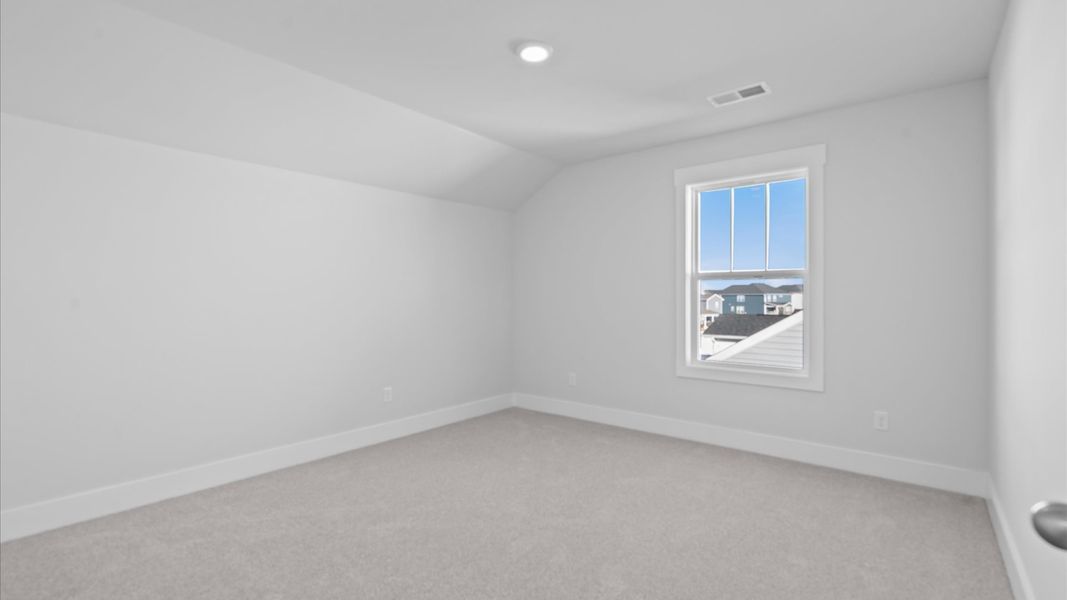 First-rate bedroom with plush carpeting and large windows that provide an open, airy feel