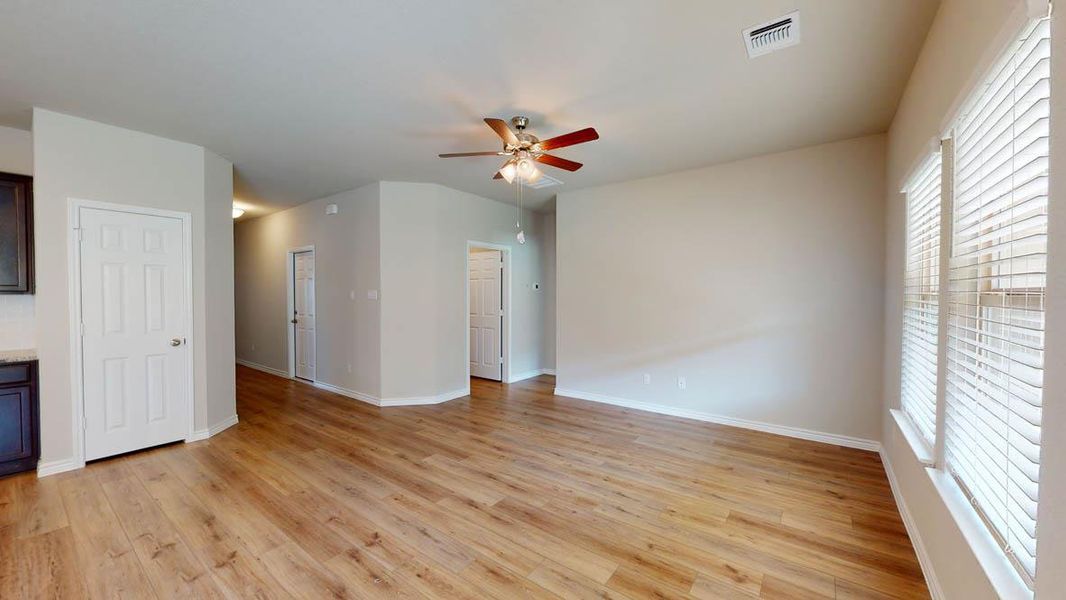 Unfurnished living room featuring ceiling fan and light wood-style flooring