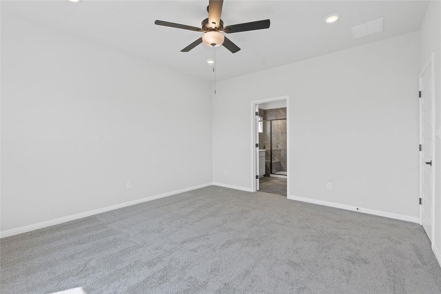 Carpeted empty room with ceiling fan and recessed lighting