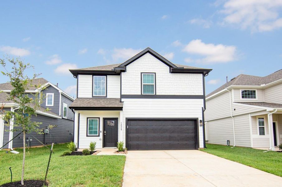 Front exterior of a new home in River's Edge, Conroe, TX, highlighting curb appeal (Image 2). Front exterior of a new home in River's Edge, Conroe, TX, highlighting curb appeal (Image 2).