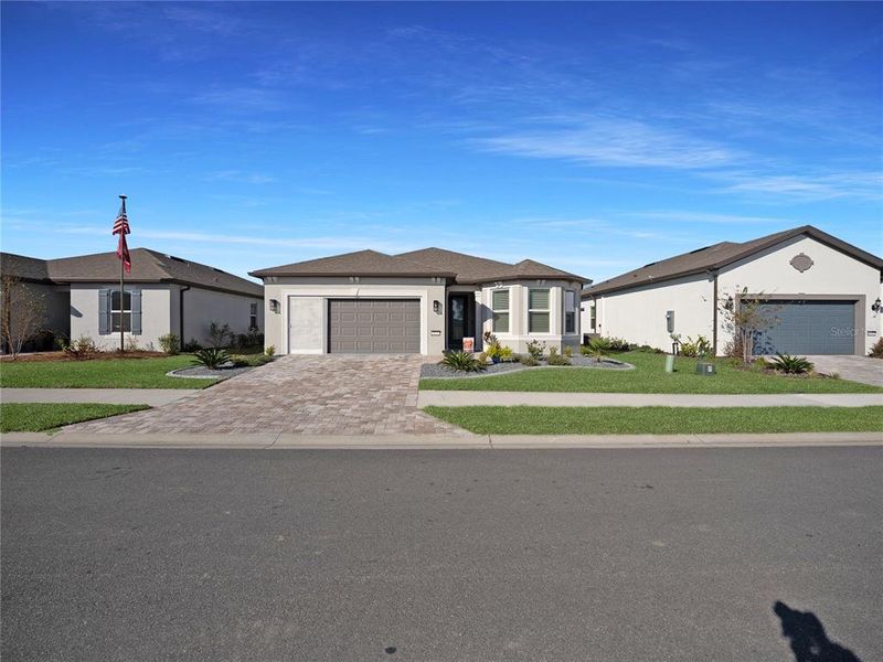 Front exterior of a new home in Del Webb Stone Creek, Ocala, FL, highlighting curb appeal (Image 23).