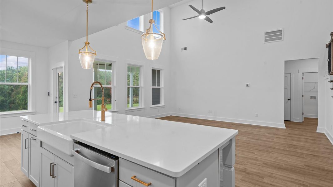 Memorable meals begin in this vibrant kitchen with pendant lighting and a thoughtfully designed island