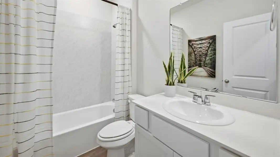 Full bathroom featuring vanity and shower / bath combination with curtain Full bathroom featuring vanity and shower / bath combination with curtain