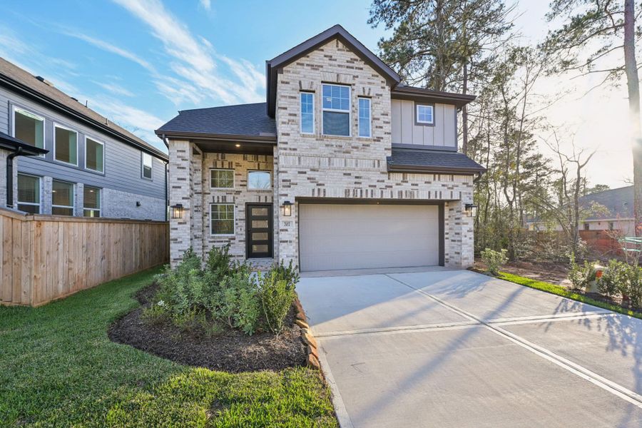 Front exterior of a new home in The Woodlands Hills, Willis, TX, highlighting curb appeal (Image 25).