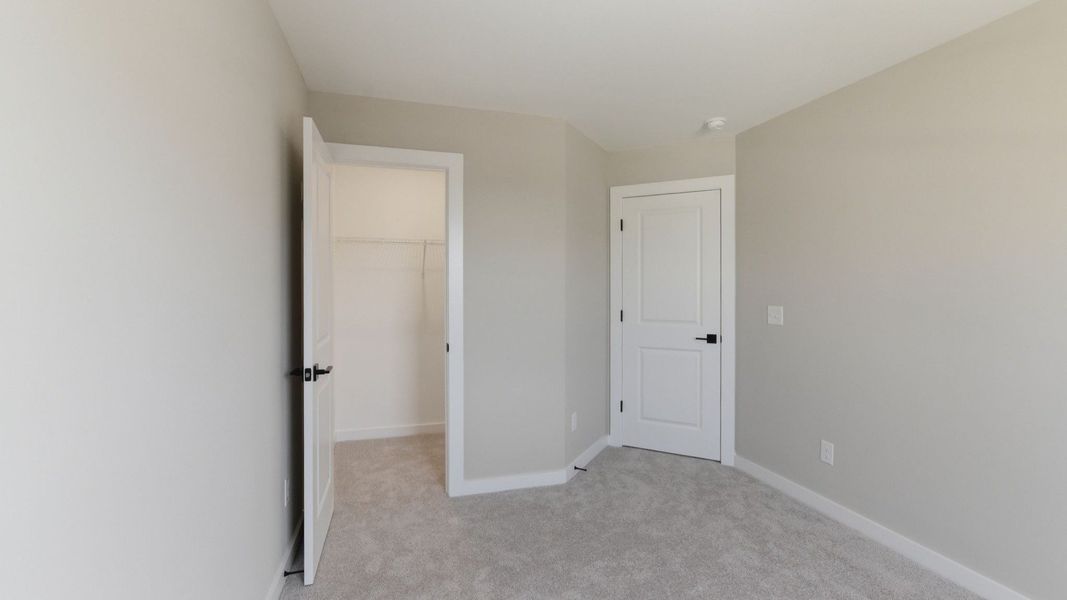 Bedroom with carpet and closet