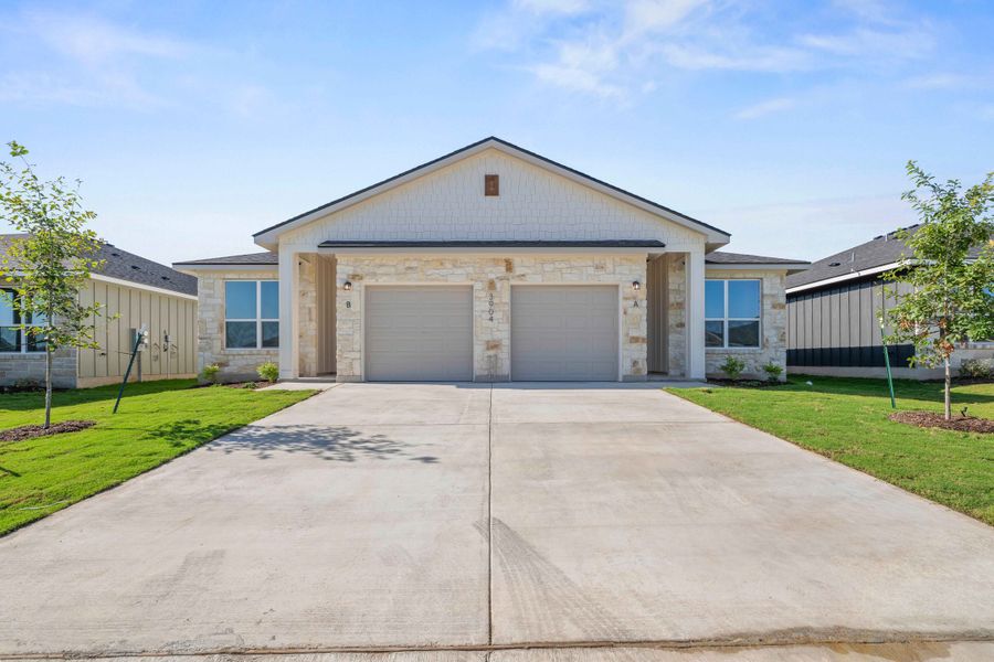 Front exterior of a new home in The Preserve at Thousand Oaks Duplexes, Killeen, TX, highlighting curb appeal (Image 1). Front exterior of a new home in The Preserve at Thousand Oaks Duplexes, Killeen, TX, highlighting curb appeal (Image 1).