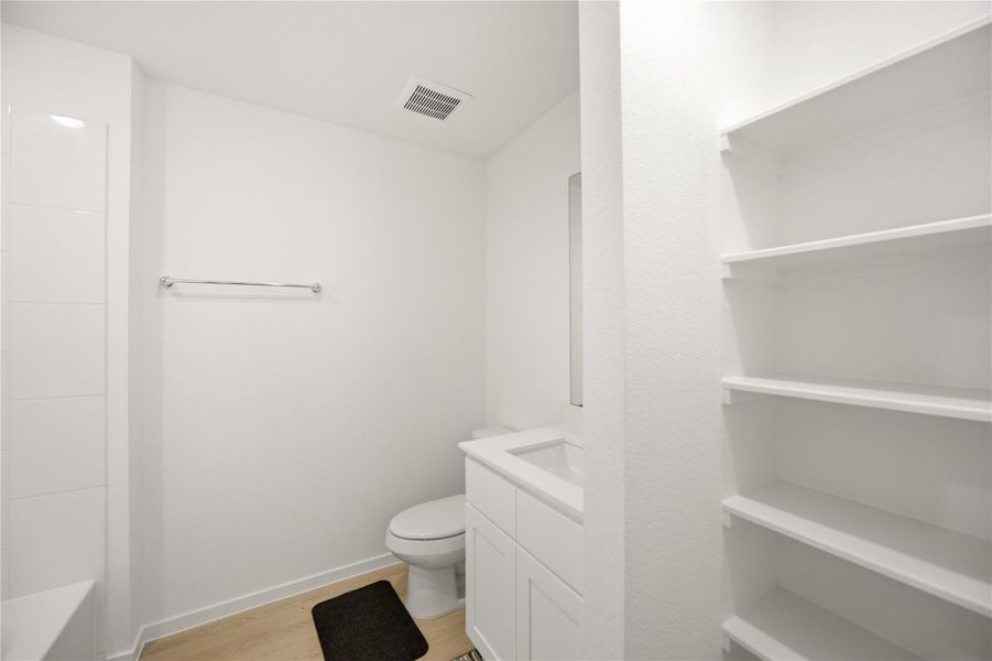 Primary closet — Large walk-in closet with built-in shelving. Primary closet — Large walk-in closet with built-in shelving.