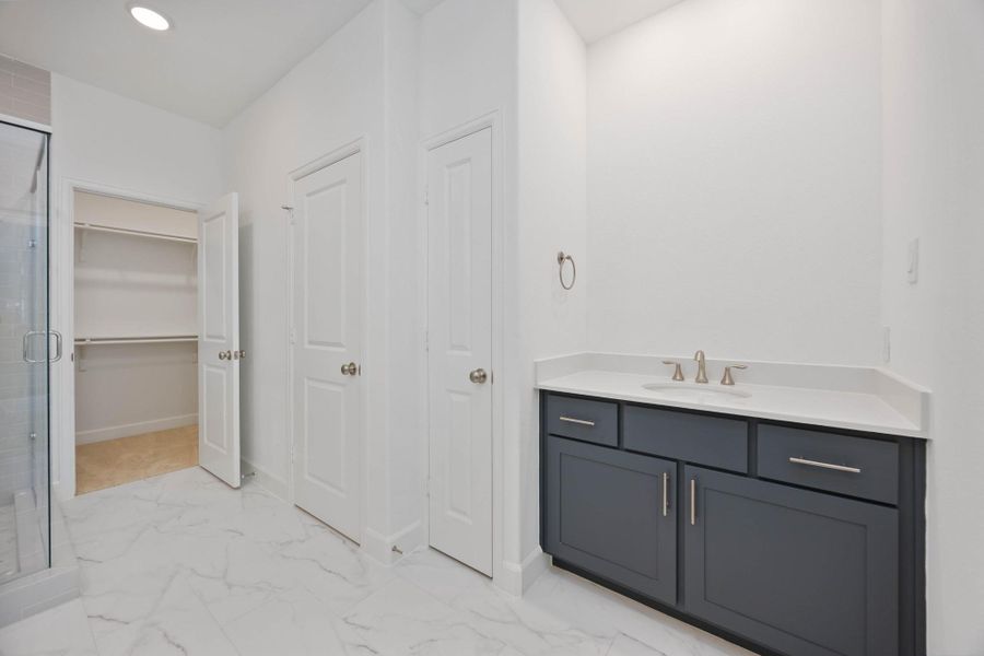 Double vanities = double the convenience. Plenty of counter space and storage keeps busy mornings running smoothly. (Mirrors will be installed prior to close.)