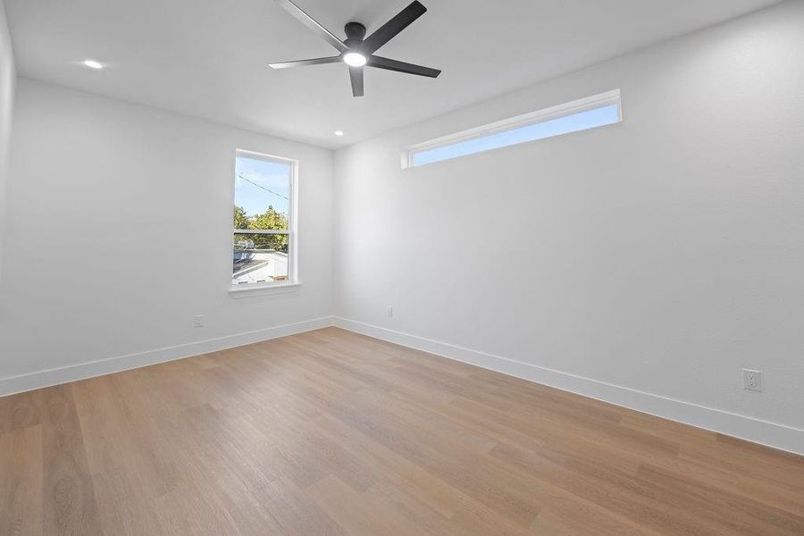 Spare room with light wood-type flooring and ceiling fan