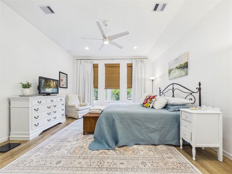 This Primary Suite is picture perfect with tall ceilings, a wall of windows overlooking the backyard, LVP flooring and a luxurious en-suite bathroom and extra large walk-in closet.