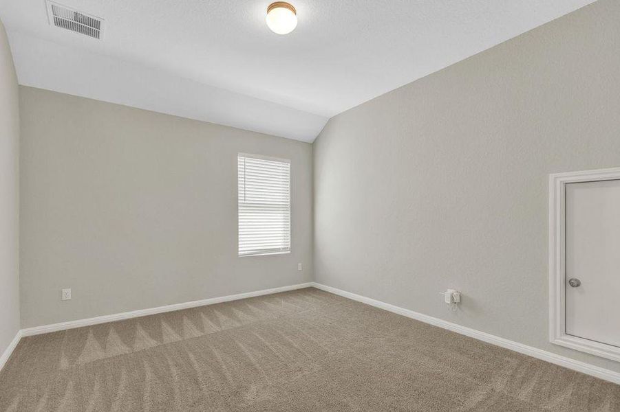 Unfurnished room featuring carpet and vaulted ceiling Unfurnished room featuring carpet and vaulted ceiling