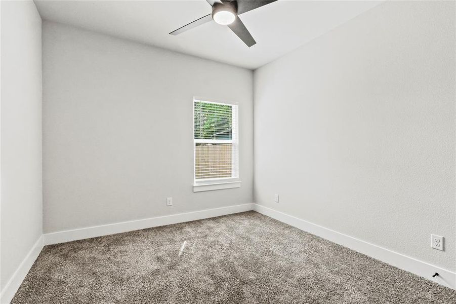 Spare room featuring carpet floors and a ceiling fan Spare room featuring carpet floors and a ceiling fan