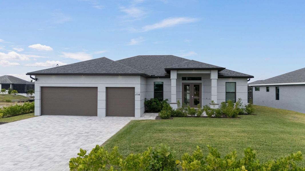 Front exterior of a new home in , Cape Coral, FL, highlighting curb appeal (Image 1). Front exterior of a new home in , Cape Coral, FL, highlighting curb appeal (Image 1).