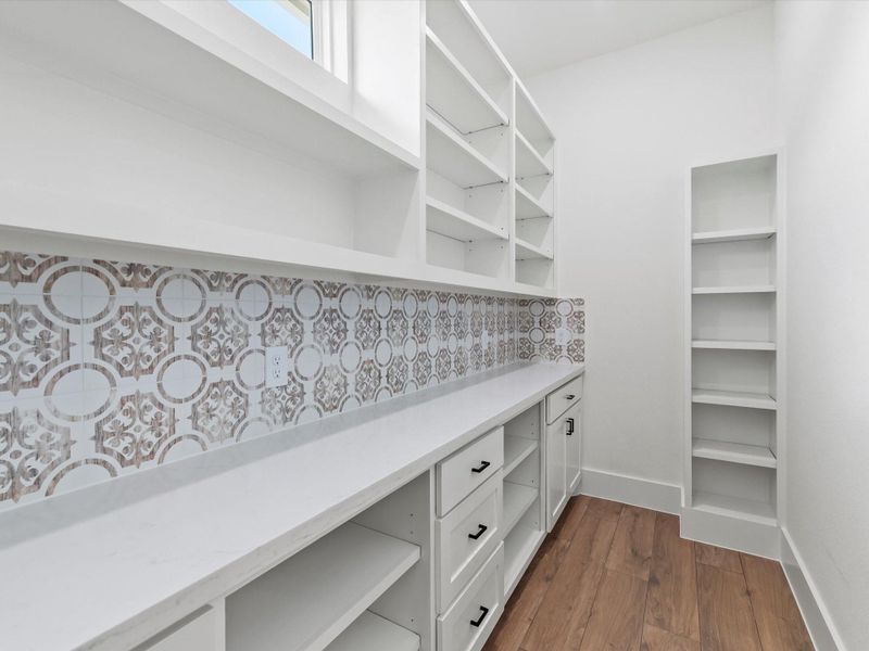 Huge walk-in custom pantry with stylish back splash and plenty of moveable shelves and drawers. Huge walk-in custom pantry with stylish back splash and plenty of moveable shelves and drawers.