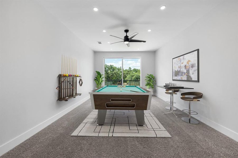 Game room on the upper level with a patio overlooking the back yard. Virtually staged.