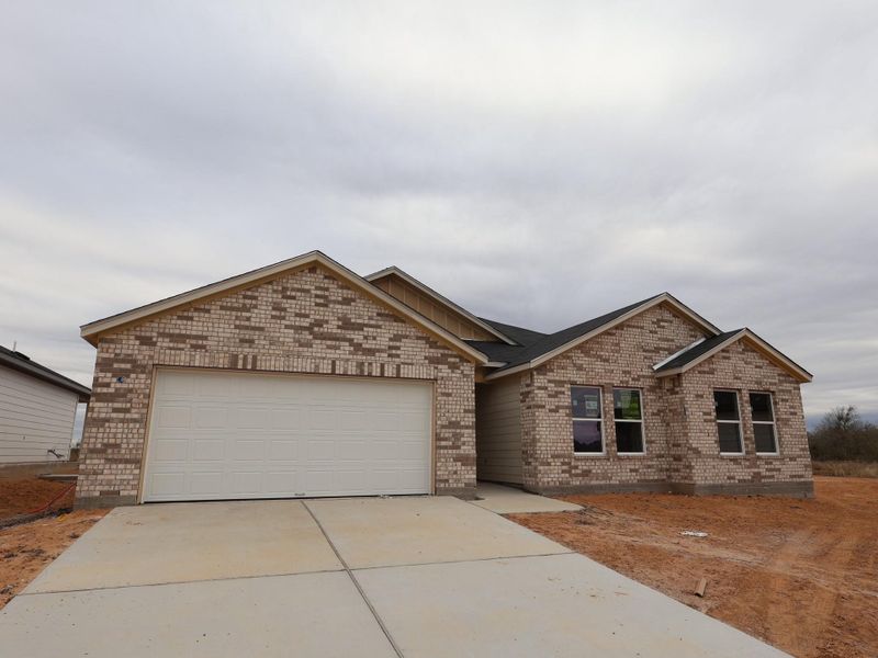 Front exterior of a new home in Carillon, Manor, TX, highlighting curb appeal (Image 1). Front exterior of a new home in Carillon, Manor, TX, highlighting curb appeal (Image 1).