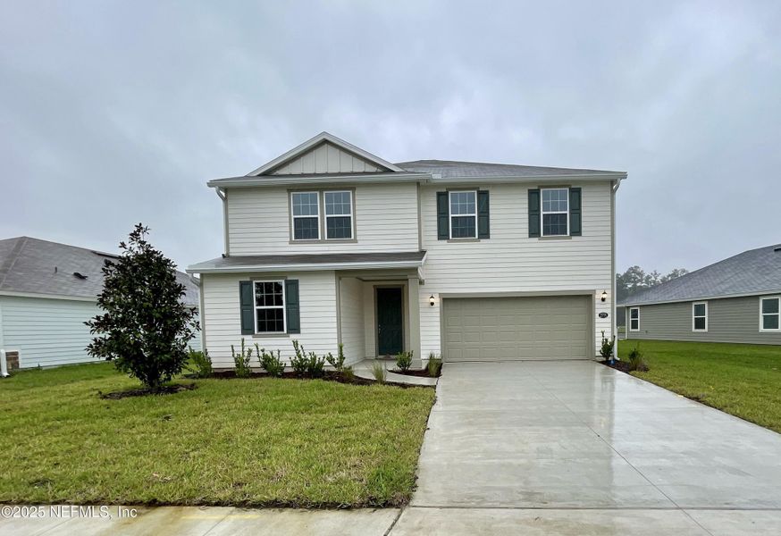 Front exterior of a new home in Anabelle Island - Executive Series, Green Cove Springs, FL, highlighting curb appeal (Image 1).