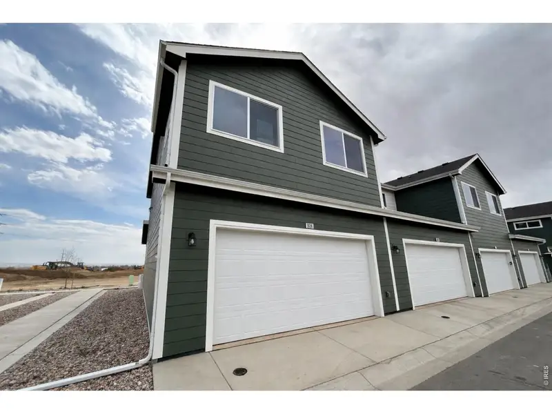 Front exterior of a new home in Liberty Draw, Evans, CO, highlighting curb appeal (Image 2). Front exterior of a new home in Liberty Draw, Evans, CO, highlighting curb appeal (Image 2).