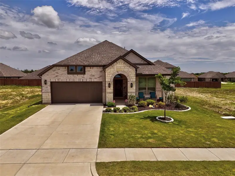 Front exterior of a new home in , Venus, TX, highlighting curb appeal (Image 21).