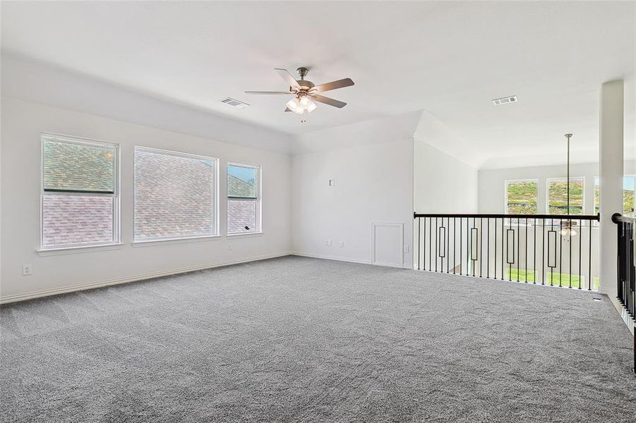 Unfurnished room with ceiling fan and carpet