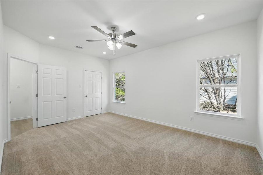 Unfurnished bedroom with light colored carpet, baseboards, recessed lighting, and ceiling fan Unfurnished bedroom with light colored carpet, baseboards, recessed lighting, and ceiling fan