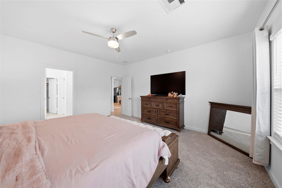 From this angle, the primary suite showcases abundant natural light, elegant double doors opening to the en-suite bath, and generous proportions to comfortably fit a complete bedroom suite. From this angle, the primary suite showcases abundant natural light, elegant double doors opening to the en-suite bath, and generous proportions to comfortably fit a complete bedroom suite.