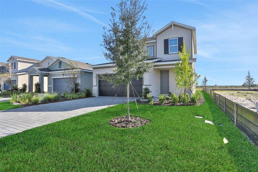 Front exterior of a new home in Turnleaf, Punta Gorda, FL, highlighting curb appeal (Image 2). Front exterior of a new home in Turnleaf, Punta Gorda, FL, highlighting curb appeal (Image 2).