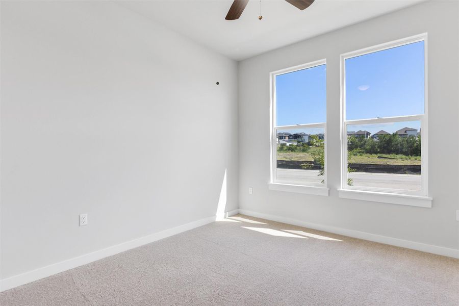 Unfurnished room featuring carpet and a ceiling fan