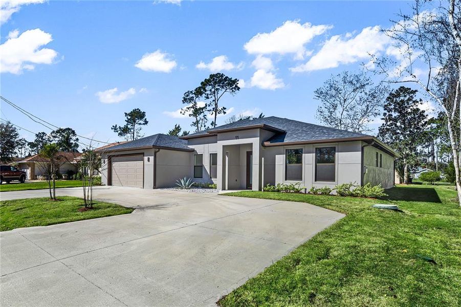 Front exterior of a new home in , Palm Coast, FL, highlighting curb appeal (Image 24).